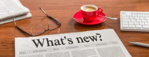 A newspaper on a wooden desk – Whats new